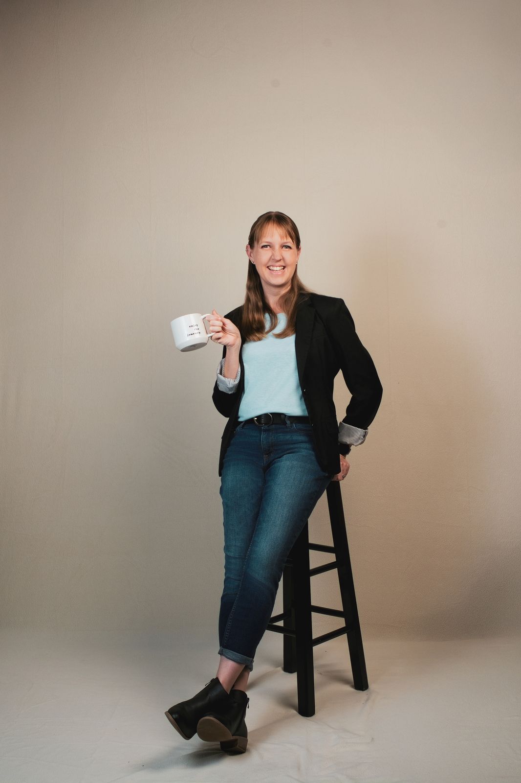 Christen Hartig, LCSW, smiling with a cup of coffee