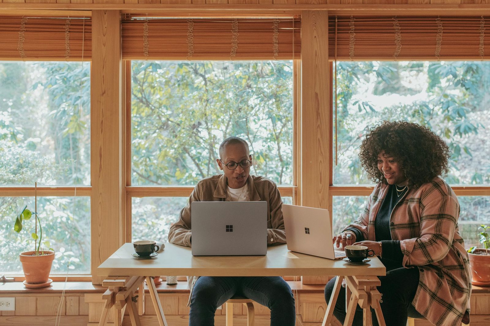 A couple working together on laptops at their kitchen table