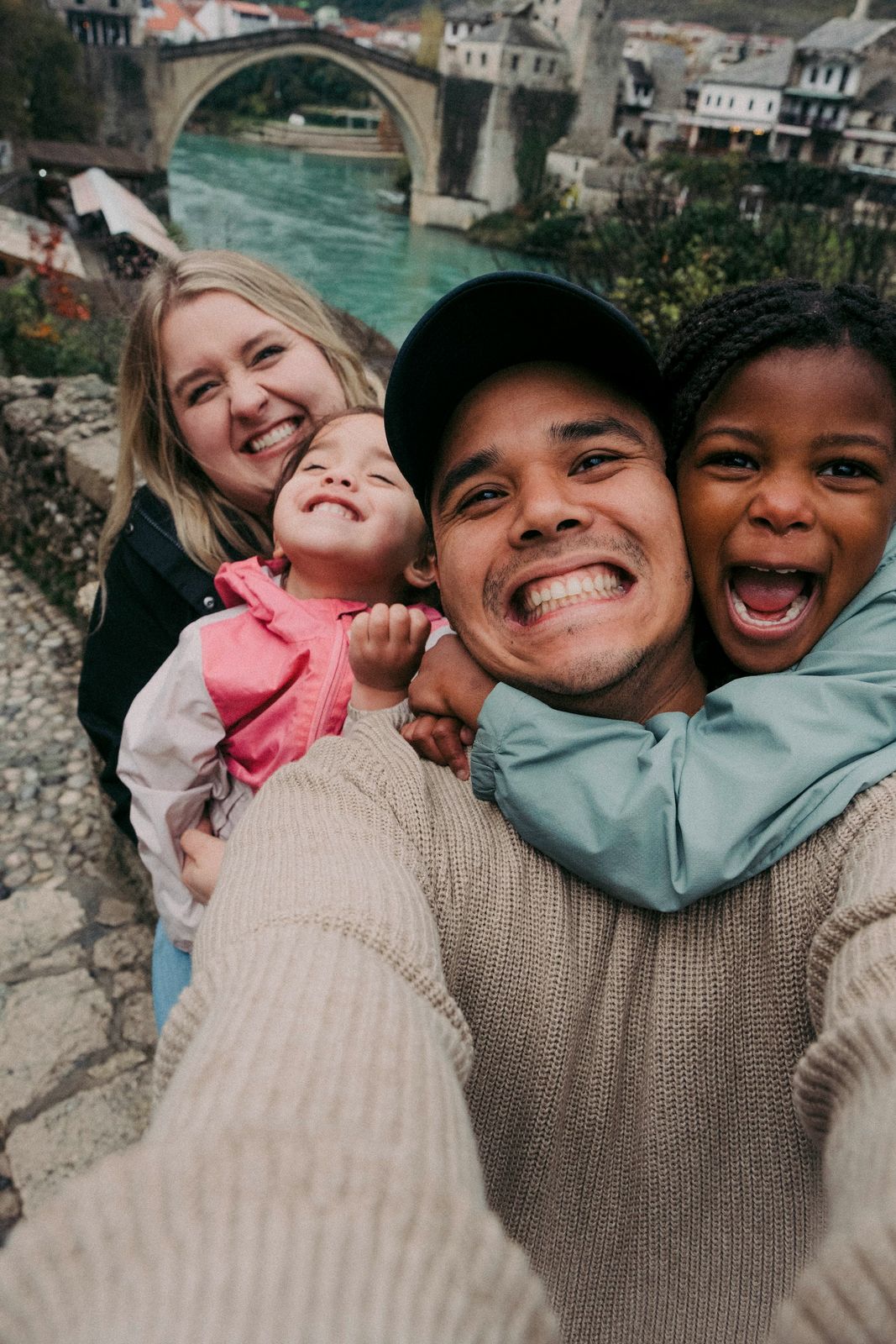 A smiling family taking a selfie together outdoors